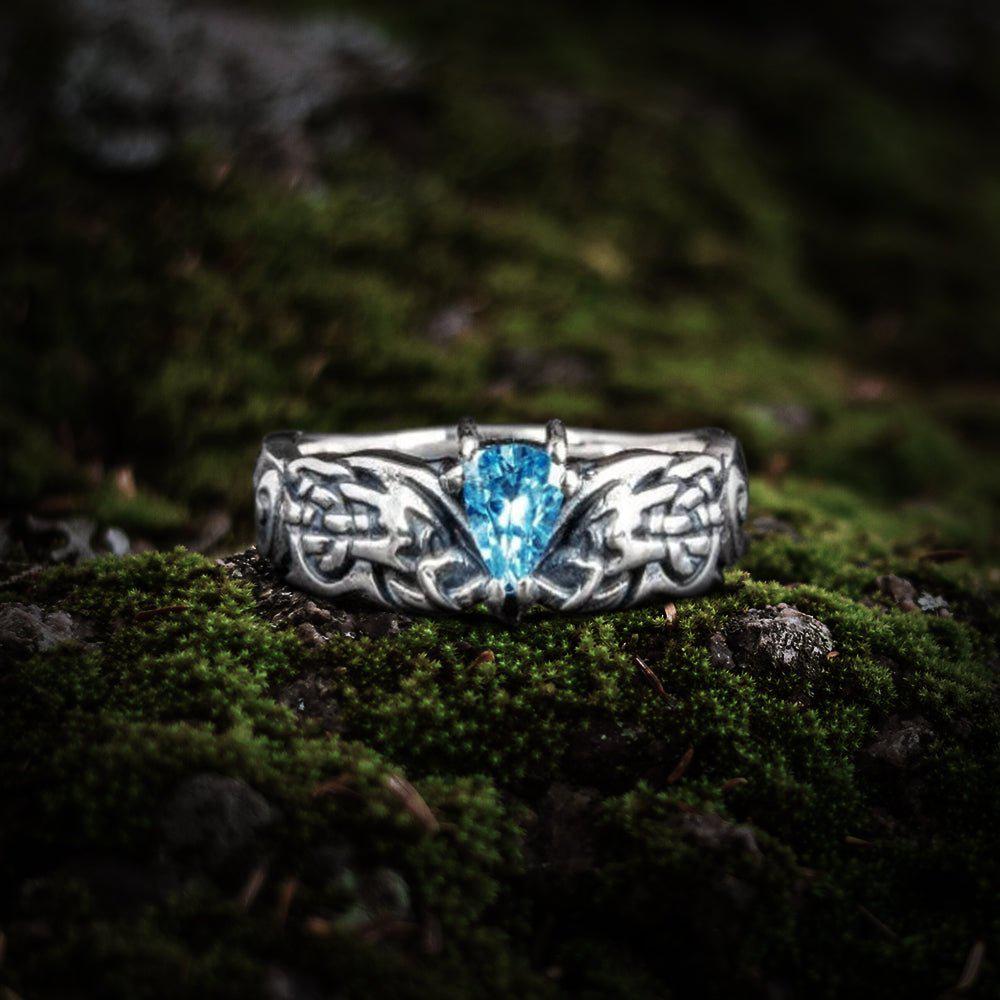 Sterling silver Renaissance ring with an ornate band and a brilliant blue cubic zirconia.