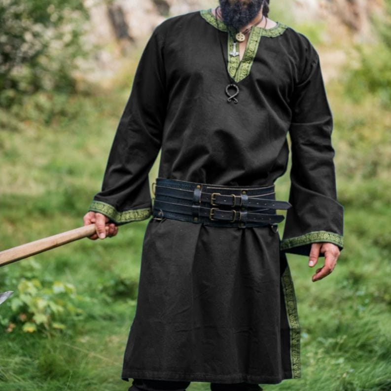 Black cotton Renaissance tunic with green embroidered trim, worn with a leather belt.