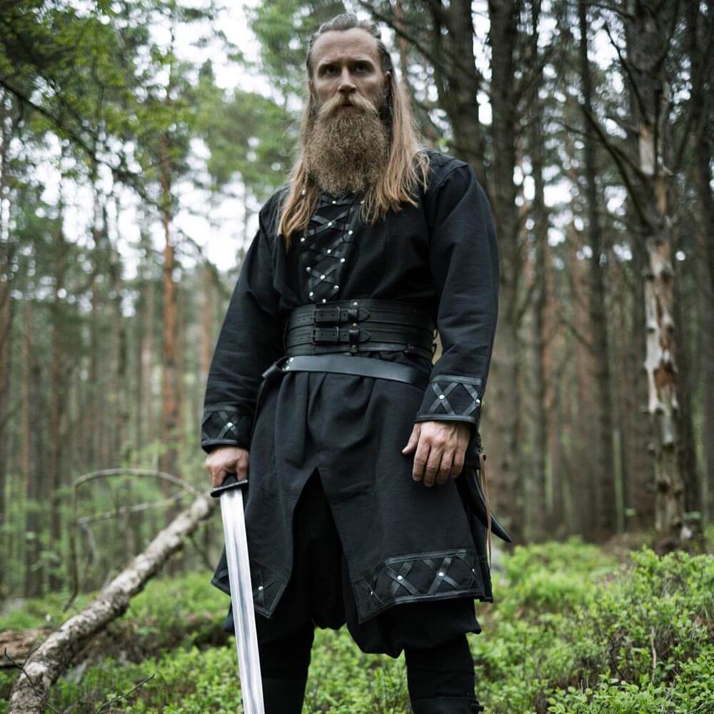 Black long-sleeve Renaissance tunic with genuine leather accents and belt, worn by a man holding a sword in a forest.
