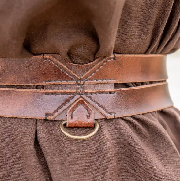 Brown faux leather Renaissance twin strap belt with metal ring, worn over a brown tunic.