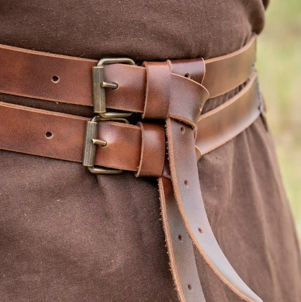 Brown Renaissance twin strap faux leather belt with metal buckles, worn over a brown tunic.