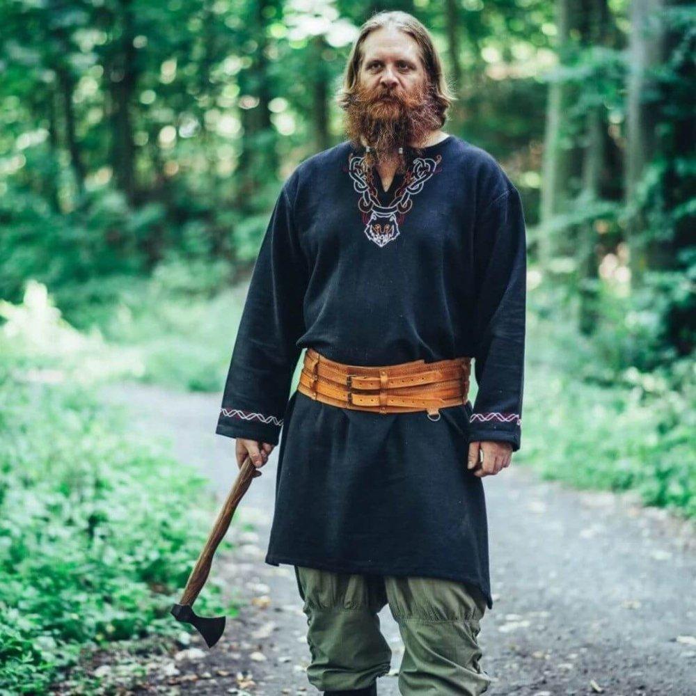 Man in a black Renaissance tunic with hand-embroidered neckline, brown belt, and an axe.