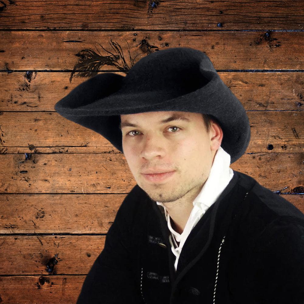 Man wearing a dark gray wool Renaissance hat with a wide brim and subtle feather plume.