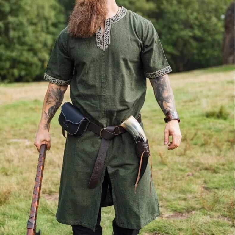 Green 100% cotton Renaissance tunic with embroidered V-neck and sleeves, worn by a bearded man.