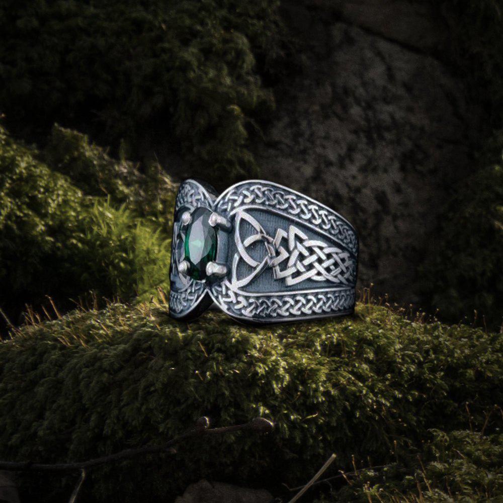 Renaissance-inspired sterling silver ring with a luminous green cubic zirconia and Celtic knotwork.