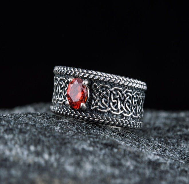 Sterling silver Renaissance ring with intricate knotwork and a brilliant red cubic zirconia.