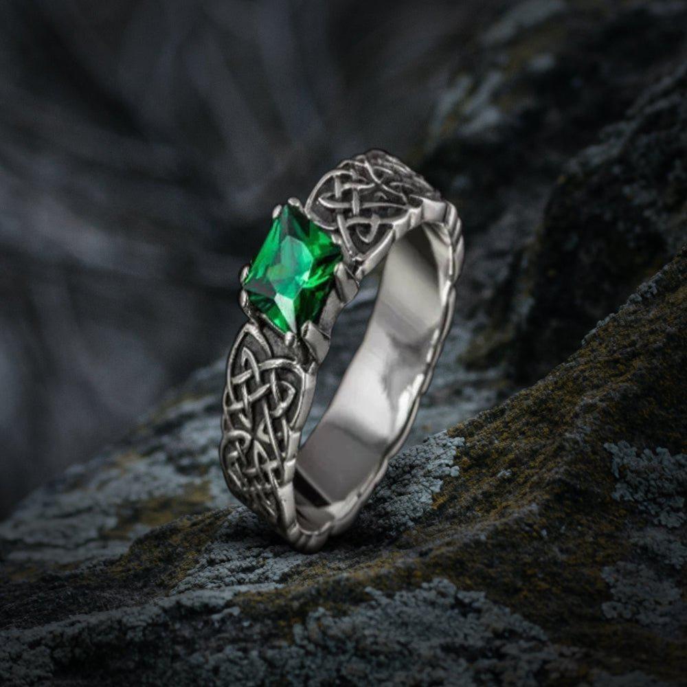 Sterling silver Renaissance ring with intricate Celtic knotwork and a vivid green cubic zirconia stone.