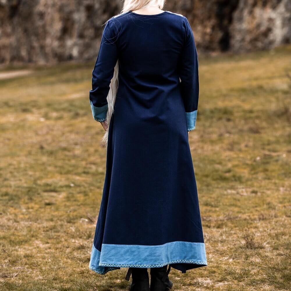 Dark blue Renaissance dress with light blue trim and cross-stitch embroidery, seen from behind.