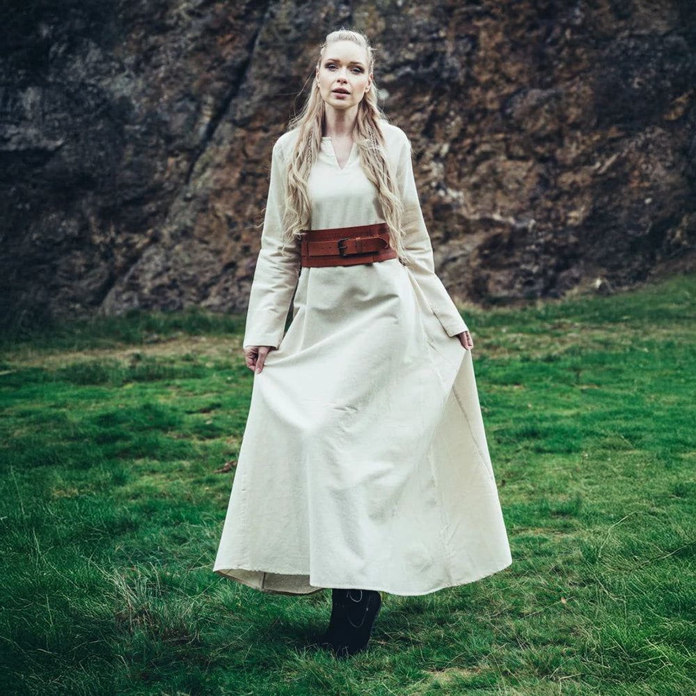 Woman in a natural cotton Renaissance underdress with straight sleeves and a brown leather belt.