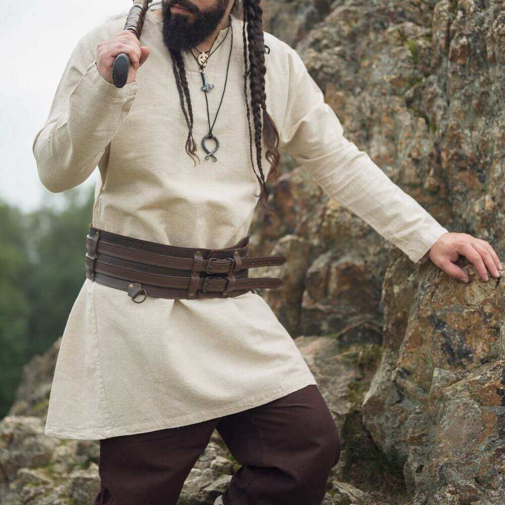 Natural linen Renaissance tunic, thigh-length, classic neckline, light beige, worn by a man with a brown belt.