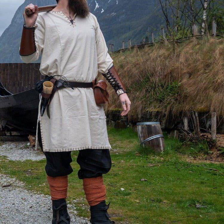 Natural cotton Renaissance tunic with knee-length cut, long sleeves, and stitched border.
