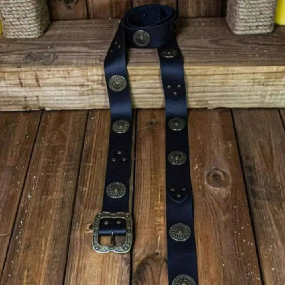 Black Noble Renaissance Belt with ornate bronze medallions and decorative buckle displayed on rustic wood floor.