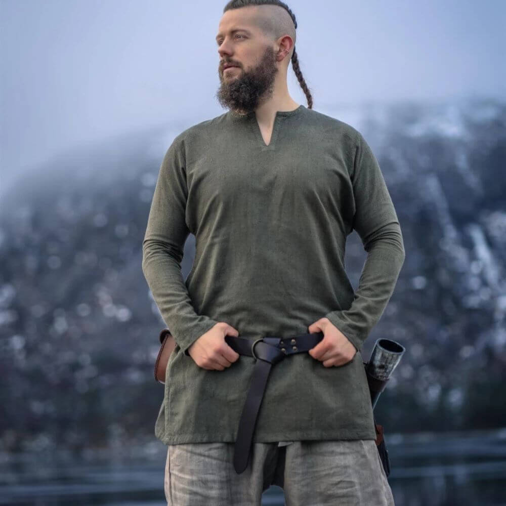 Man wearing an olive green linen Renaissance tunic with a classic neck, thigh-length cut, and a black belt.