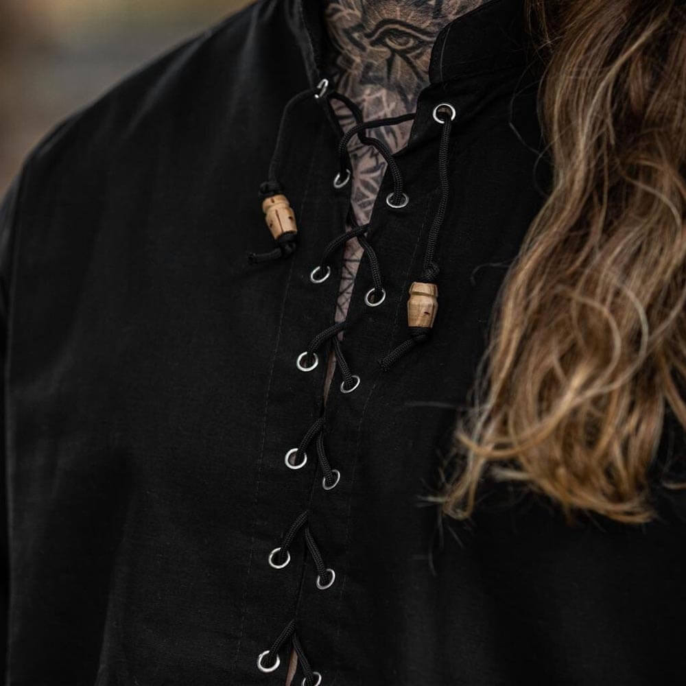 Black Renaissance shirt with front cord lacing, metal eyelets, and wooden button accents.