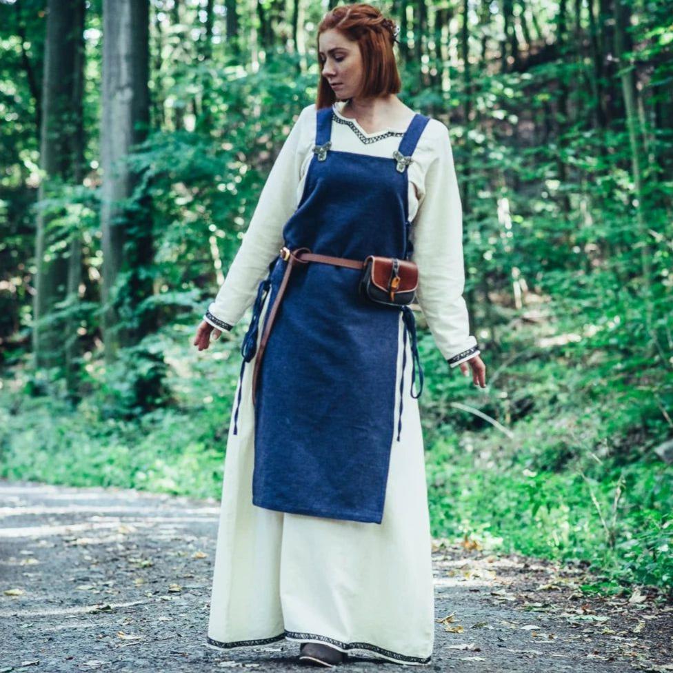 Woman in a deep blue cotton Renaissance overdress with side lacing over a cream underdress.