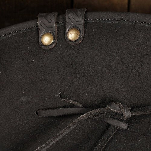 Close-up of a black Renaissance tricorn hat, showing brass buttons, leather straps, and a tied leather cord.