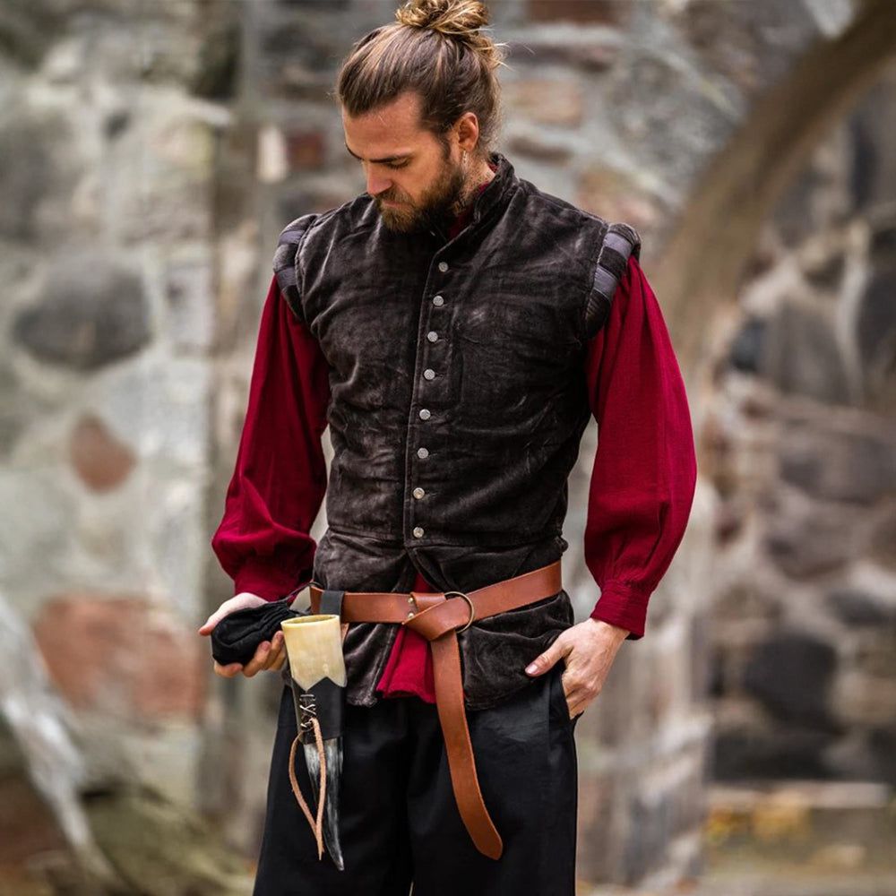Man in a dark brown velvet Renaissance sleeveless doublet over a red shirt, with a leather belt and horn.