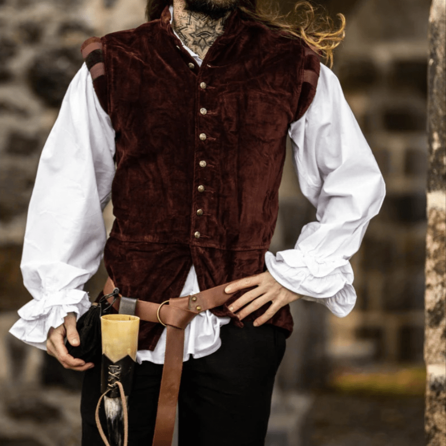 Renaissance sleeveless red velvet doublet with gold buttons over a white shirt.