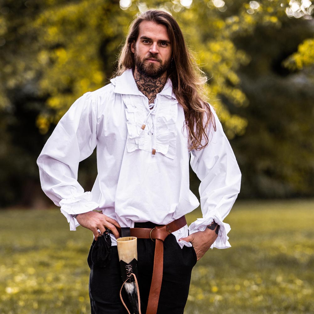 White cotton Renaissance shirt with ruffled neckline, cuffs, and lace-up front, worn by a man outdoors.