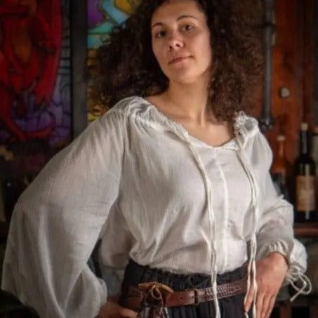 Woman in ivory Renaissance chemise with adjustable drawstring neck and wrists, loose crepe cotton.