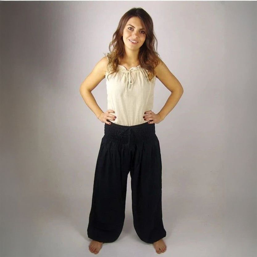 Black Renaissance wide-leg trousers with elastic high waist, made from flowing viscose.