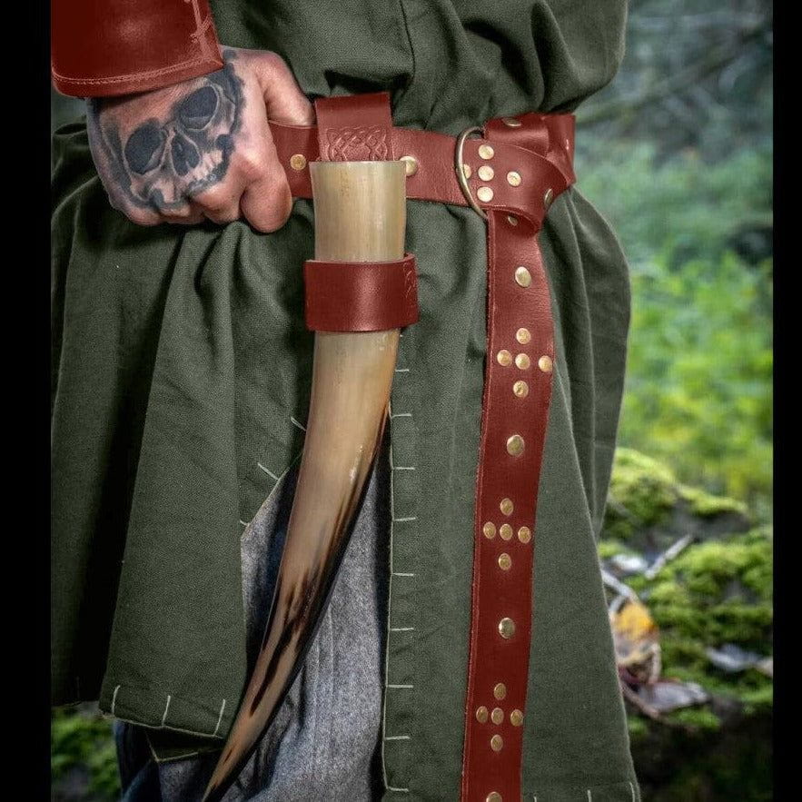 Brown Renaissance full-grain leather belt with decorative gold rivets and ring closure, holding a drinking horn.