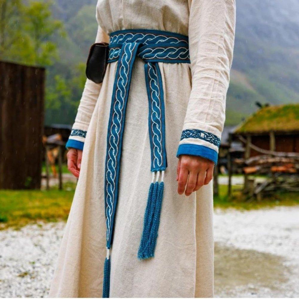 Renaissance cotton tie belt, blue with white twisted embroidery and tassels, worn over a cream dress.