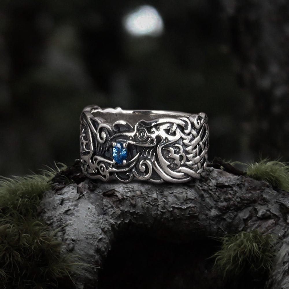 Silver Renaissance ring with detailed raven design and a blue gemstone.