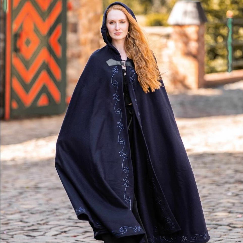 Renaissance navy wool blend hooded cloak with elegant embroidery and wolf head clasp.