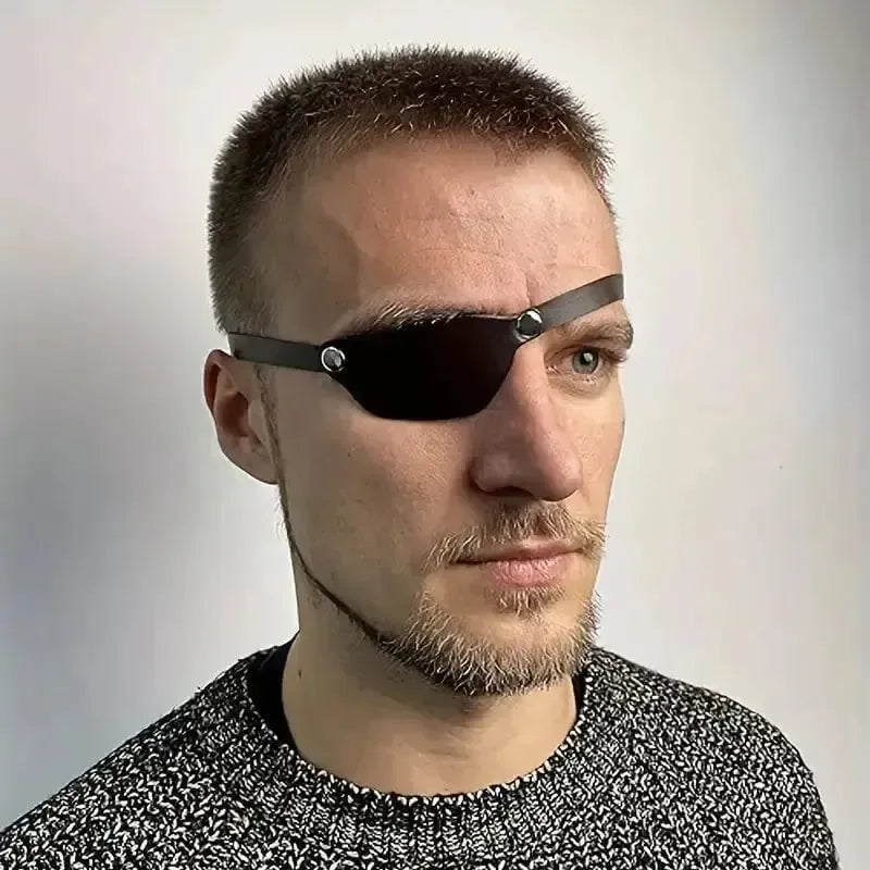 Black faux leather Renaissance eye patch with metal rivets and adjustable strap on a man.
