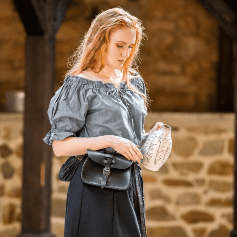 Gray-blue Renaissance cotton short-sleeve blouse with laced neckline, worn off-shoulder by a woman.