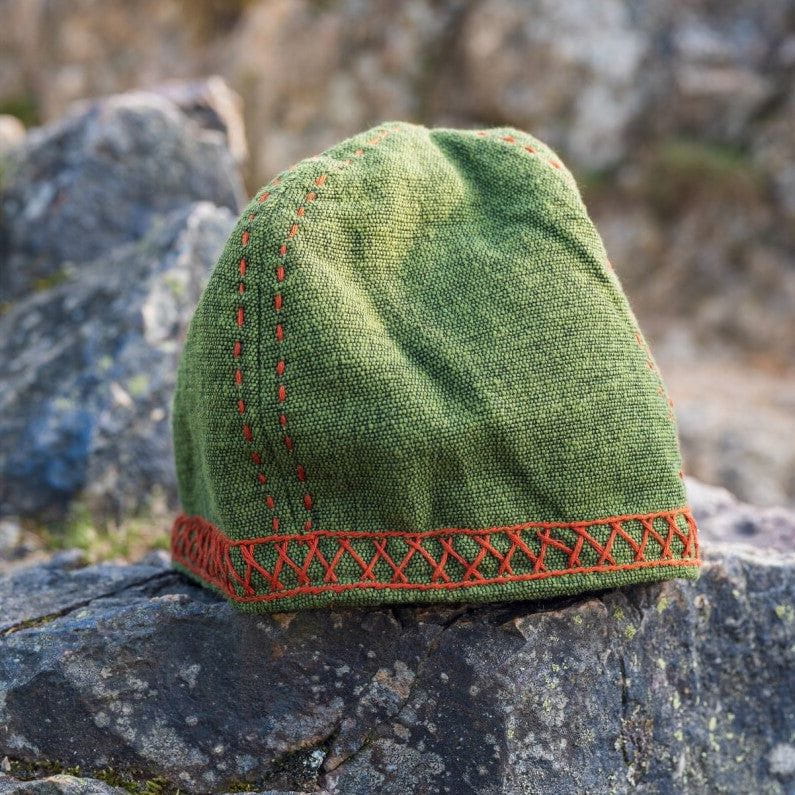 Green cotton Renaissance cap with red geometric embroidery and decorative band.