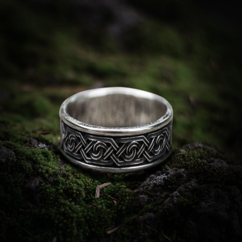 Handcrafted 925 sterling silver Renaissance ornament ring with intricate flowing design on moss.