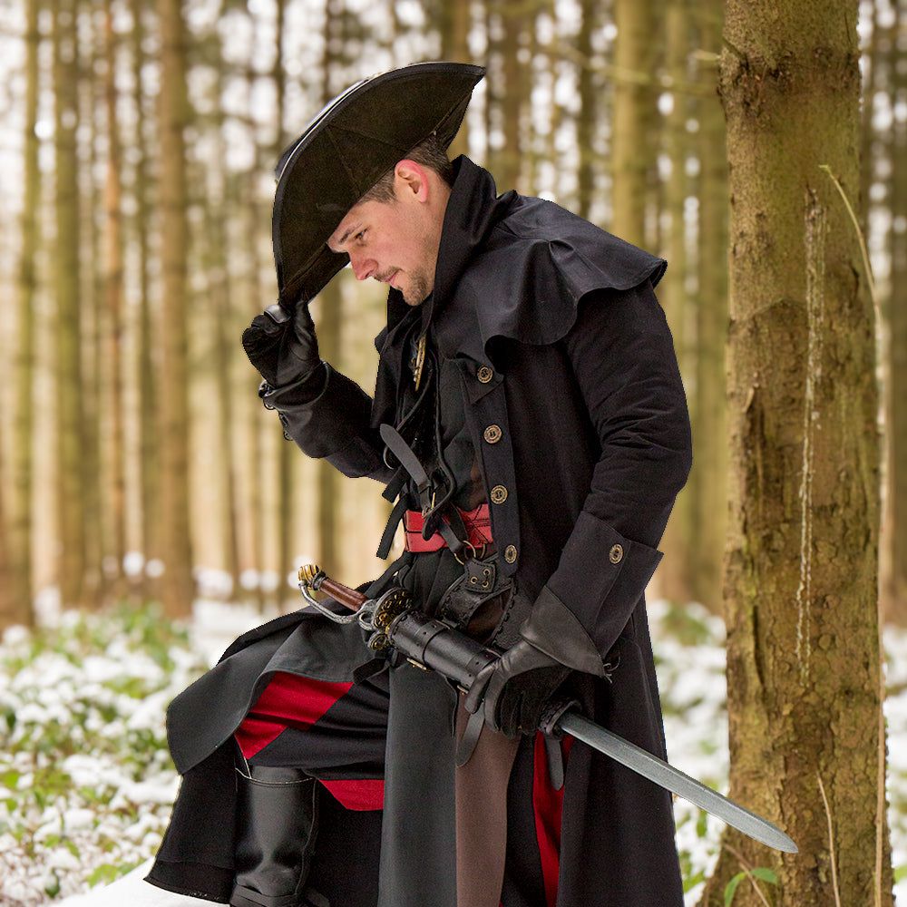 Renaissance black canvas pirate overcoat with shoulder mantle, ornate buttons, and tricorn hat in a snowy forest.
