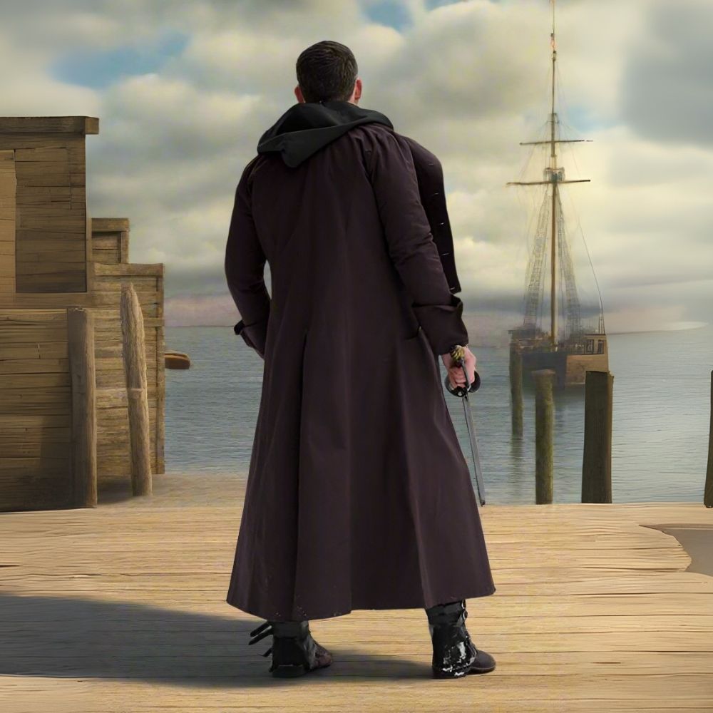 Brown canvas Renaissance pirate overcoat with shoulder mantle, full-length, worn by a man on a dock.