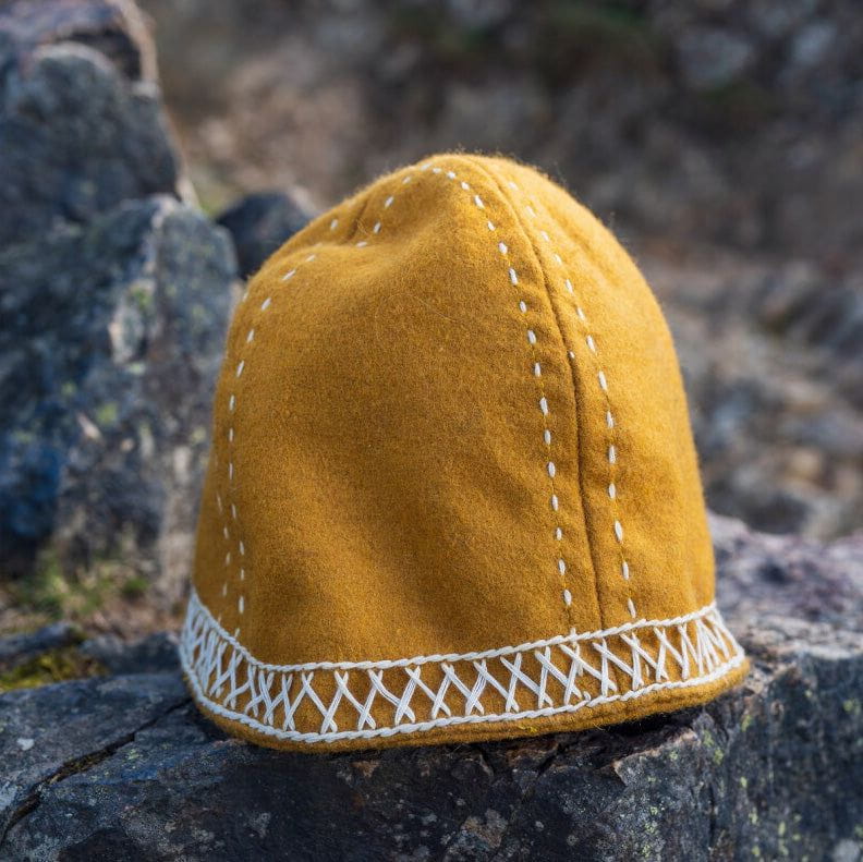 Mustard yellow wool Renaissance cap with white geometric stitching and decorative latticed band.