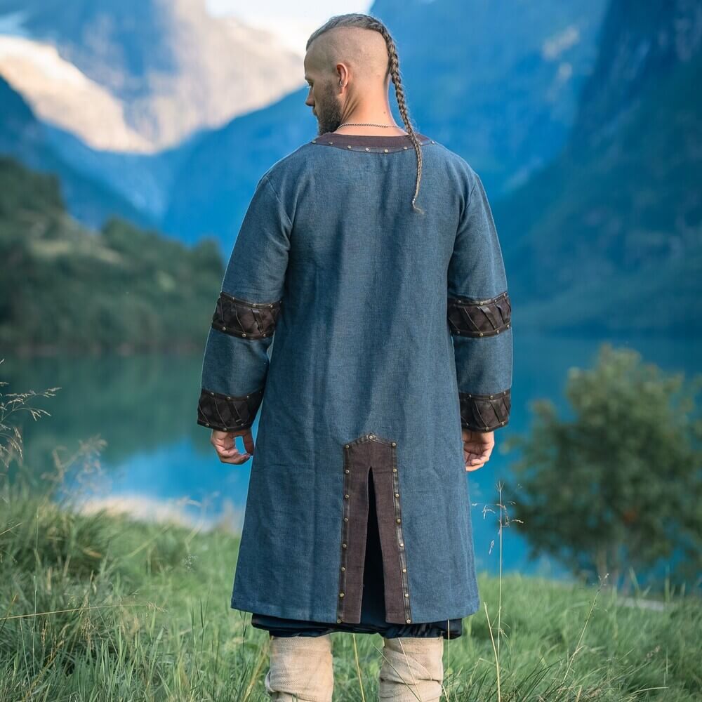 Renaissance blue linen-look tunic with brown leather trim, metal rivets, and X-pattern accents.