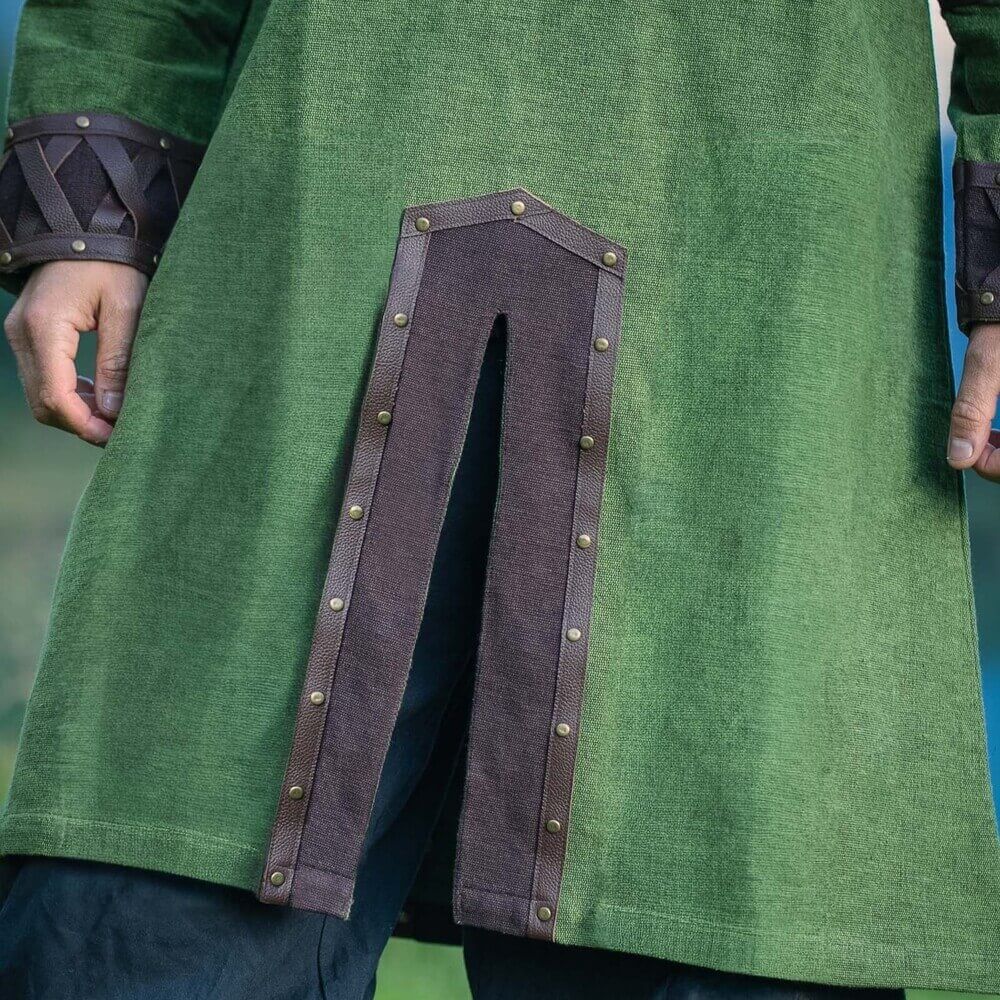 Green Renaissance tunic with ornate leather trim, metal rivets, and front slit.