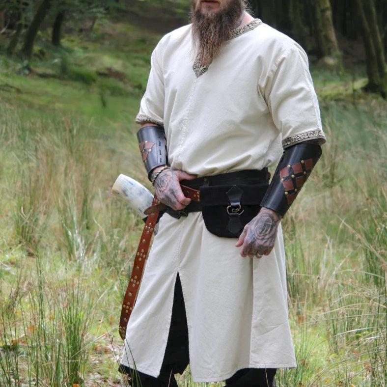 Renaissance nobleman's natural off-white cotton tunic with embroidered V-neck and sleeve trim.