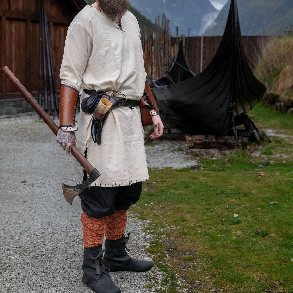 Natural long-sleeved Renaissance tunic in off-white cotton with stitched borders, worn by a man holding an axe.
