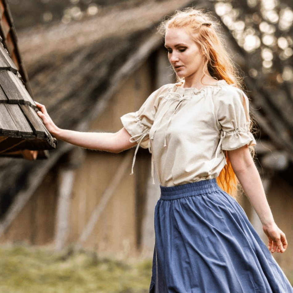 Natural short-sleeve Renaissance blouse with adjustable laced neckline, worn by a woman with red hair.