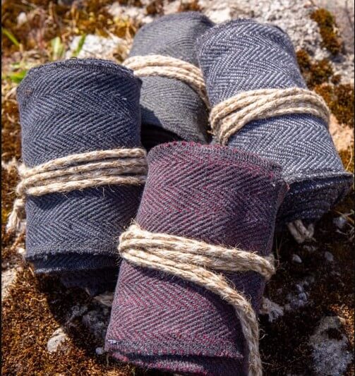 Renaissance woolen leg wraps in black, gray, and brown herringbone, tied with twine.