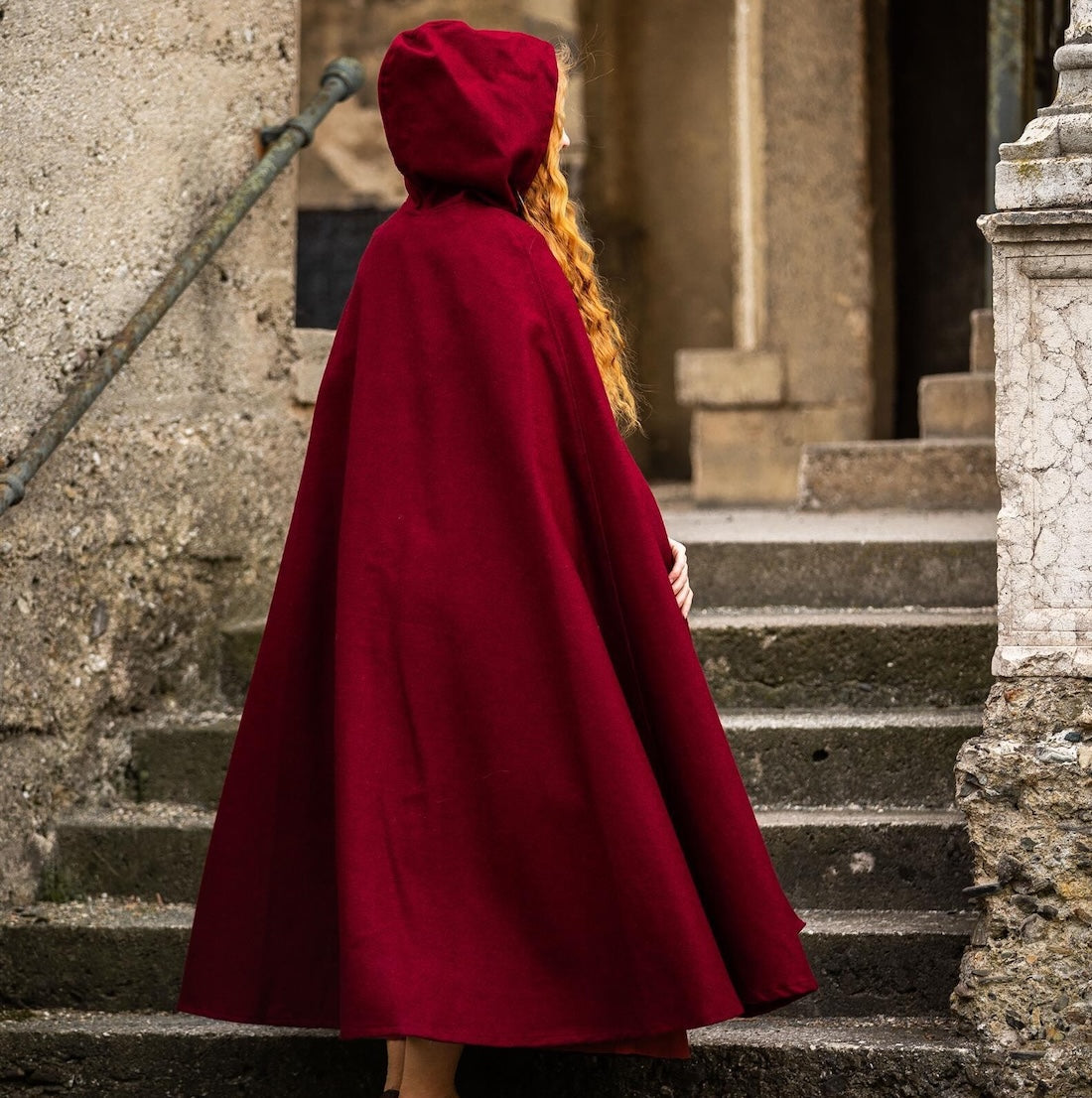 Red wool cloak worn with the hood up
