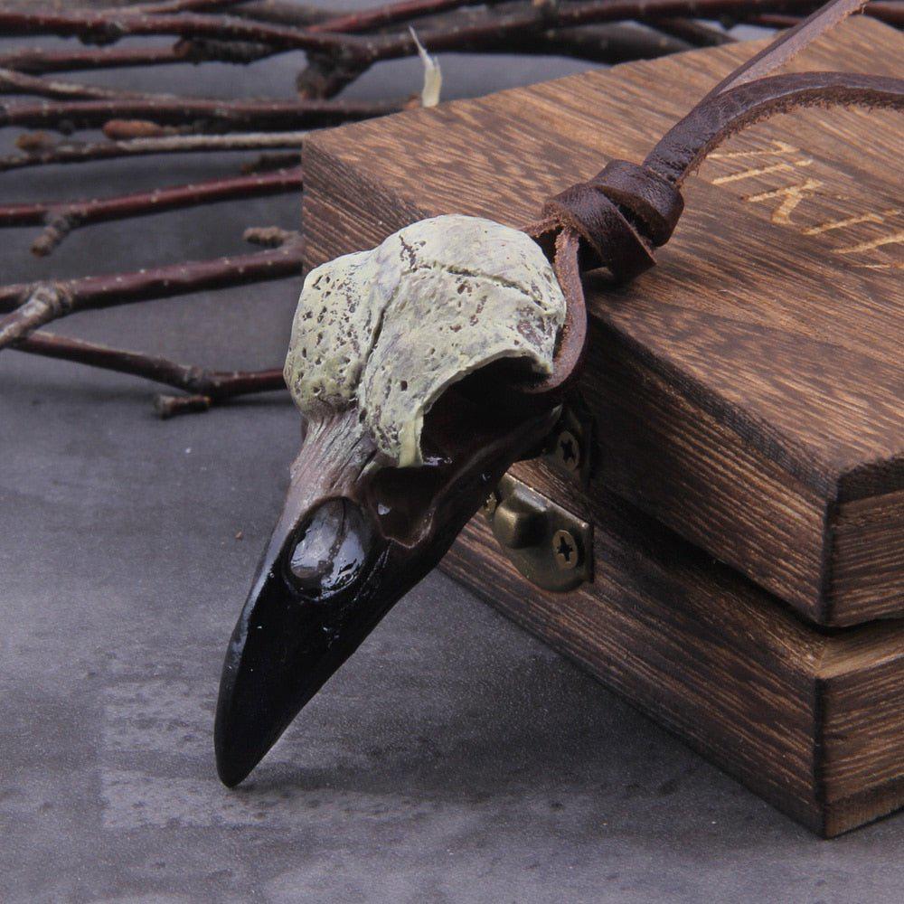 Front view of a hand painted raven skull pendant