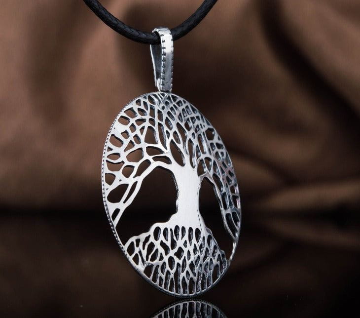 Sterling silver tree of life pendant with detailed roots and branches on a cord
